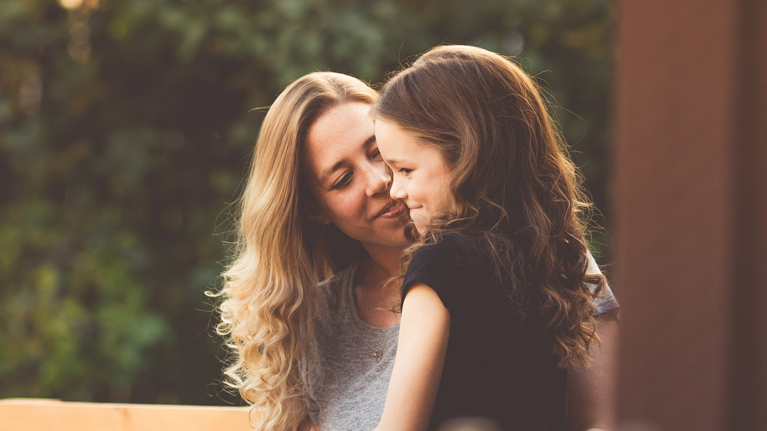 SMH_BreastHealth Woman talks to little girl outdoors.